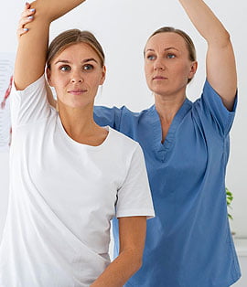 A woman and her nurse stretching their arms.