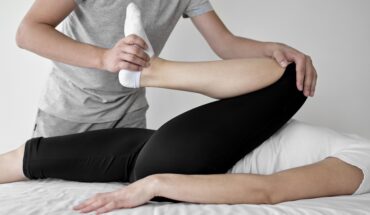 A person is getting their leg examined by an osteopath.